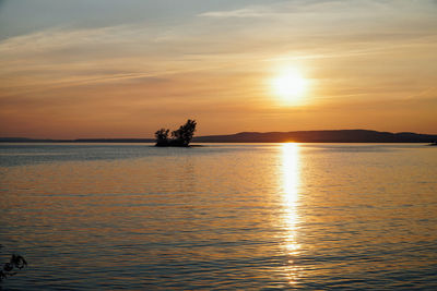 Scenic view of lake against romantic sky at sunset