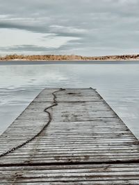 Pier over lake against sky