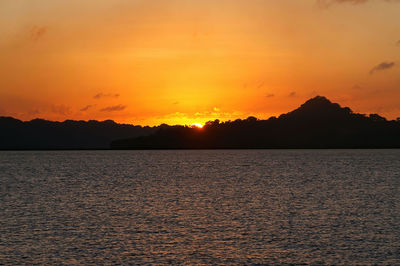 Scenic view of sea against romantic sky at sunset