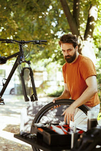 Side view of man sitting on street