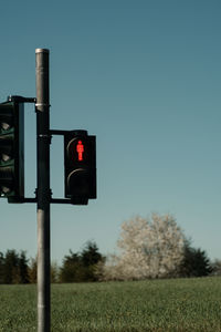 Road sign against clear sky