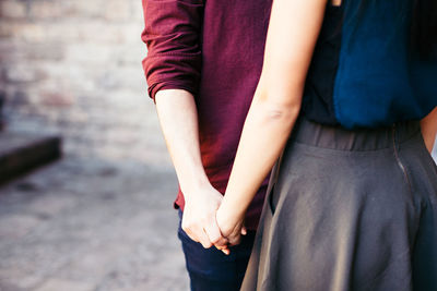 Close-up of couple holding hands