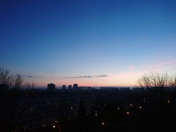 Silhouette cityscape against sky during sunset