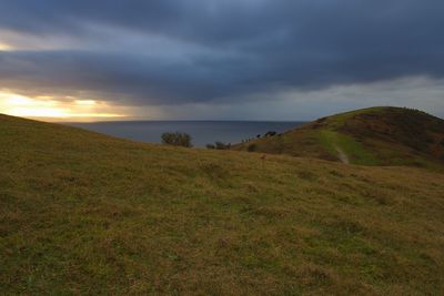 Scenic view of green landscape against sky