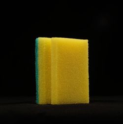 Close-up of yellow glass against black background