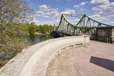 View of bridge over river against cloudy sky