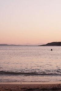 Scenic view of sea against clear sky during sunset