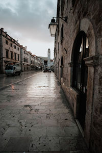 Empty alley amidst buildings in city