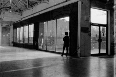 Rear view of silhouette man standing in building