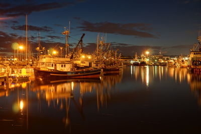 Boats in harbor at night