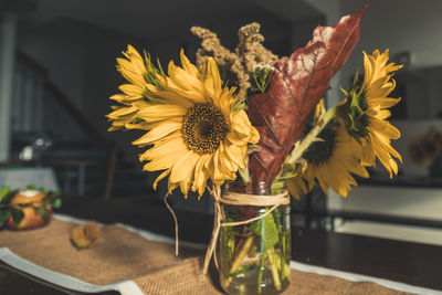 Close-up of yellow flower vase on table