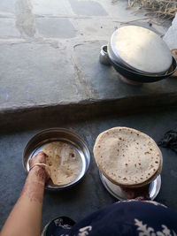 Cropped image of woman holding chapattis