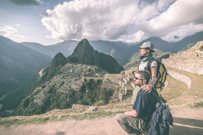 People standing against mountains