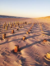 Scenic view of desert against clear sky during sunset