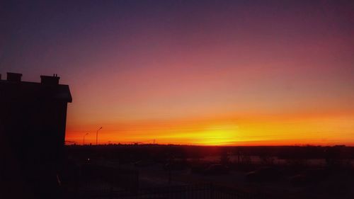 Silhouette city against sky during sunset