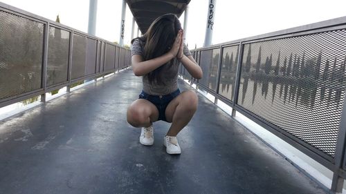 Full length of girl on railing by bridge