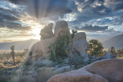 Rock formation against sky during sunset