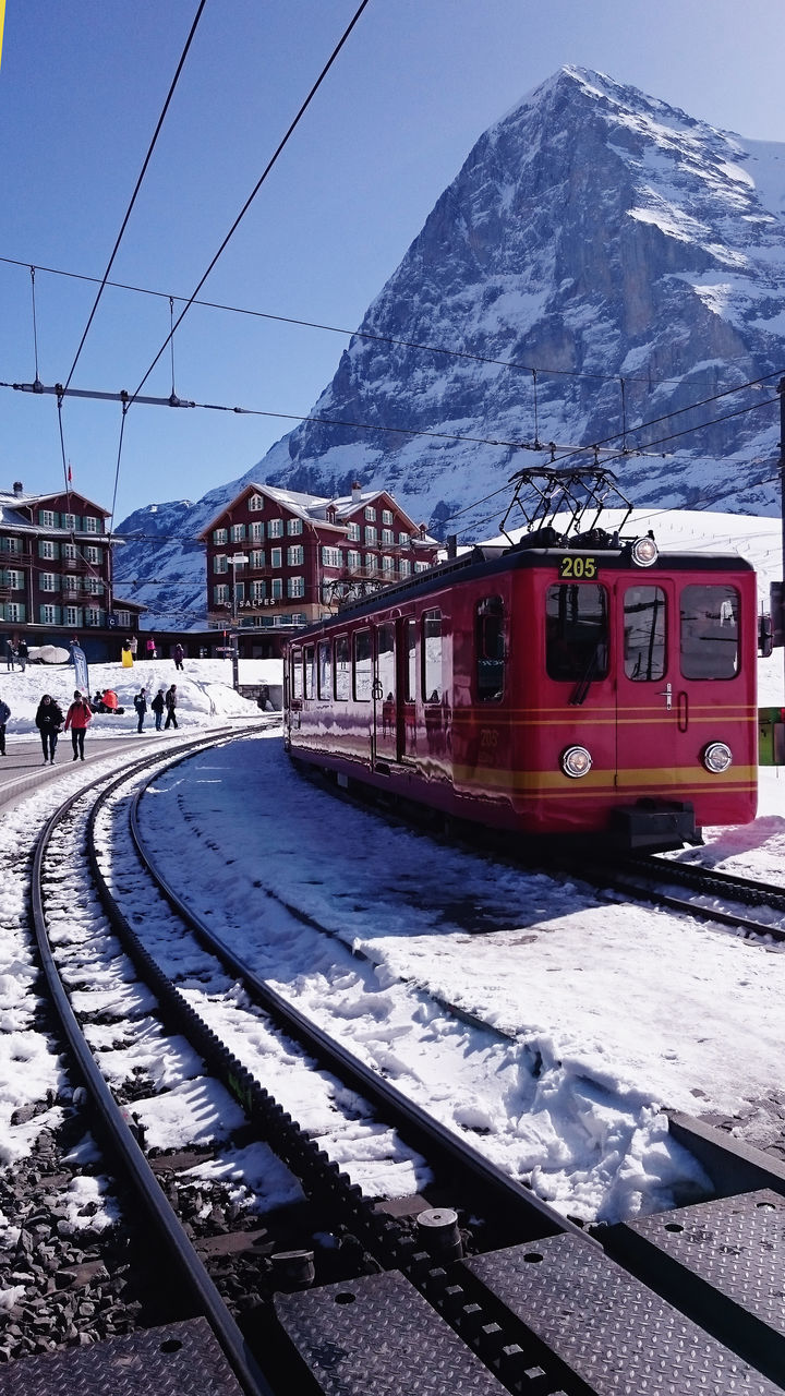 TRAIN BY RAILROAD TRACKS IN WINTER