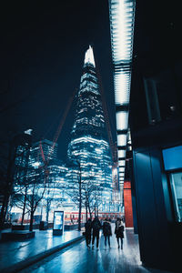 People in illuminated building at night