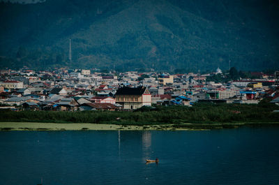 High angle view of townscape by river in town