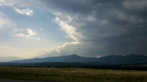 Scenic view of mountains against cloudy sky