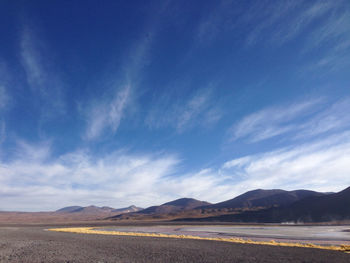 Scenic view of mountains against cloudy sky