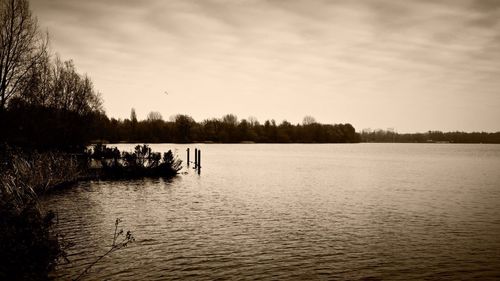 Scenic view of lake against cloudy sky