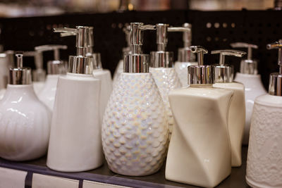 Glass liquid soap dispenser on a shelf in a store
