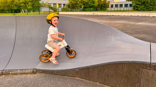 High angle view of boy riding push scooter on road
