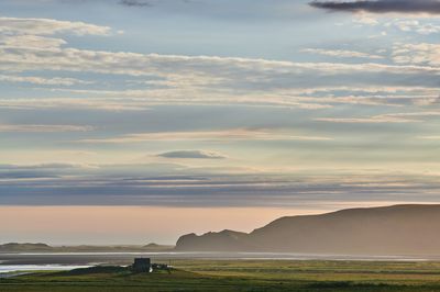 Scenic view of field against sky during sunset