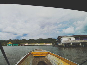 Scenic view of lake by buildings against sky
