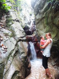 Full length of young couple on rock formation