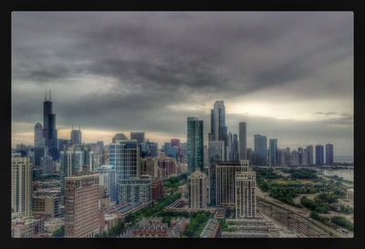 Cityscape against cloudy sky