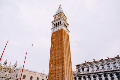 Low angle view of clock tower in city against sky