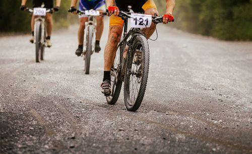 People cycling on road during event