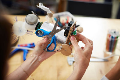 High angle view of female engineers making robot model at workshop