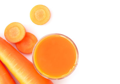 High angle view of orange juice against white background