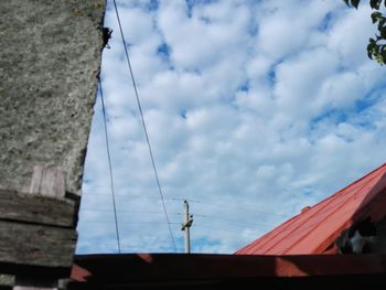 Low angle view of building against cloudy sky