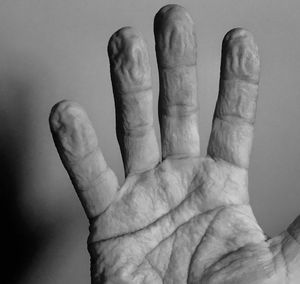 Close-up of human hand against black background