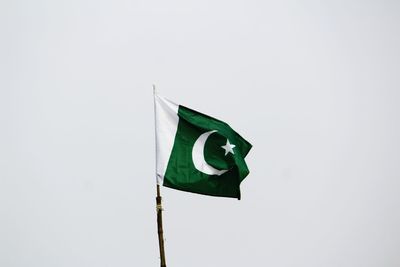 Low angle view of flag against clear sky
