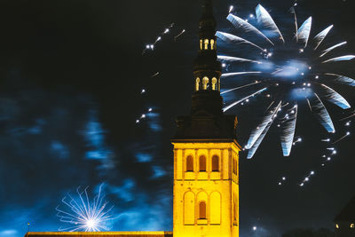 Low angle view of firework display at night