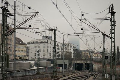 Railroad tracks and power lines on a rainy day in frankfurt.