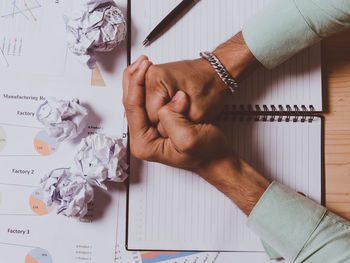 Directly above shot of man hand holding paper