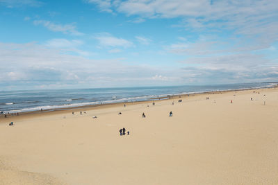 Scenic view of beach and sea against blue sky 