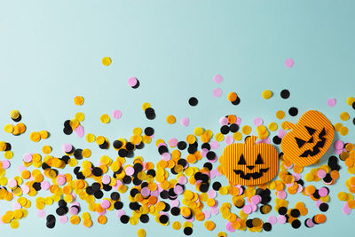 Multi colored balloons in mid-air against sky