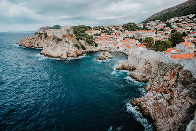 Panoramic view of sea and buildings against sky