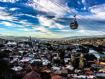 High angle view of overhead cable cars against buildings in city