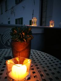 Close-up of illuminated candles on table