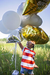 Rear view of woman with balloons