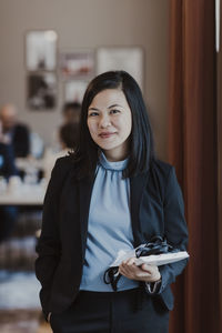 Smiling businesswoman with diary in education class